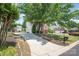 Long driveway leading to a charming home with mature trees at 6141 Abergele Ln, Matthews, NC 28104