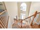Staircase leading to the front door and foyer with hardwood flooring and an elegant chandelier at 6141 Abergele Ln, Matthews, NC 28104