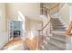 Grand foyer with hardwood floors, a staircase, and french doors leading to a home office at 6141 Abergele Ln, Matthews, NC 28104