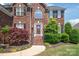 Charming brick home with a welcoming red front door at 6141 Abergele Ln, Matthews, NC 28104