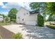 Spacious two-car garage with a wide driveway, complemented by the home's neutral siding and well-kept landscaping at 6141 Abergele Ln, Matthews, NC 28104