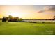 Scenic view of the golf course with lush green fairways at sunset at 6141 Abergele Ln, Matthews, NC 28104