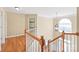 Bright hallway with hardwood floors, a staircase, and a large window letting in natural light at 6141 Abergele Ln, Matthews, NC 28104