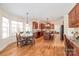 A full kitchen with dark wood cabinetry, granite countertops, a center island and a sunlit breakfast nook at 6141 Abergele Ln, Matthews, NC 28104