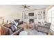 Living room with hardwood floors, neutral paint, ample seating and fireplace with built-in shelving at 6141 Abergele Ln, Matthews, NC 28104