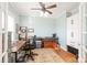 Well-lit office featuring hardwood floors, a ceiling fan, storage cabinets, and classic design at 6141 Abergele Ln, Matthews, NC 28104