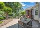 Spacious patio with dining table, seating area, and lush greenery at 6141 Abergele Ln, Matthews, NC 28104