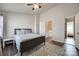 Bedroom featuring ceiling fan, gray and white bedding, and wood floor at 6374 Windsor Gate Ln, Charlotte, NC 28215