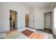 Bright bedroom with vinyl plank flooring and multiple doors, including one to the private ensuite bath at 6374 Windsor Gate Ln, Charlotte, NC 28215