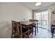 Cozy dining area featuring a wooden table, chairs, and access to the outside at 6374 Windsor Gate Ln, Charlotte, NC 28215