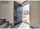 Welcoming foyer with a dark wood floor and door leading to the outside at 6374 Windsor Gate Ln, Charlotte, NC 28215