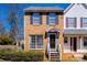 Charming brick two-story townhome with black shutters and a landscaped front yard at 6374 Windsor Gate Ln, Charlotte, NC 28215