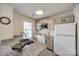 Bright kitchen featuring granite counters, white appliances, and ample cabinet space at 6374 Windsor Gate Ln, Charlotte, NC 28215