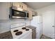 Kitchen with white appliances, subway tile backsplash, and gray cabinets at 6374 Windsor Gate Ln, Charlotte, NC 28215