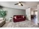 Inviting living room featuring tile floors, neutral walls, and a ceiling fan at 6374 Windsor Gate Ln, Charlotte, NC 28215
