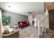 Inviting living room featuring tile floors, neutral walls, and a ceiling fan at 6374 Windsor Gate Ln, Charlotte, NC 28215