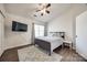 Bedroom with a ceiling fan, decorative rug, and a large window at 6374 Windsor Gate Ln, Charlotte, NC 28215