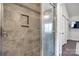 Tile shower with glass door and built-in shelving at 6374 Windsor Gate Ln, Charlotte, NC 28215