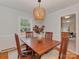 Cozy dining room featuring a wooden table, stylish light fixture, and bright natural light at 6523 Tall Oaks Trl, Charlotte, NC 28210