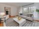 Elegant living room with a large window, hardwood floors, and neutral decor creating a welcoming atmosphere at 6523 Tall Oaks Trl, Charlotte, NC 28210