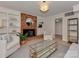 Relaxing living room with fireplace, built-in shelves, and a large window for plenty of natural light at 6523 Tall Oaks Trl, Charlotte, NC 28210