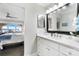 Open bathroom with a large mirror and vanity, and a peek into the bedroom and lake view at 667 Portside Dr, Davidson, NC 28036