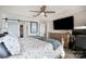 Comfortable bedroom with a ceiling fan, television, and view of a closet with sliding doors at 667 Portside Dr, Davidson, NC 28036