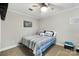 Cozy bedroom with a ceiling fan and blue and white striped bedding for a peaceful retreat at 667 Portside Dr, Davidson, NC 28036