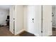 Clean and bright entryway with multiple doors and neutral-colored walls. Dark carpet at 667 Portside Dr, Davidson, NC 28036