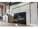 Close-up view of a modern fireplace with glass doors and a stone surround. Mantel with decor at 667 Portside Dr, Davidson, NC 28036