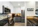 Modern kitchen features stainless steel appliances, granite counters, tile backsplash, and updated white and gray cabinets at 667 Portside Dr, Davidson, NC 28036