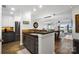 Open kitchen featuring granite countertops, gray cabinets, stainless steel appliances, and an island at 667 Portside Dr, Davidson, NC 28036