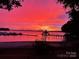 Beautiful lake view at sunset with boats docked and a charming gazebo on the pier at 667 Portside Dr, Davidson, NC 28036