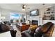 Cozy living room with a stone fireplace, built-in shelving, comfortable seating, and a large sliding glass door at 667 Portside Dr, Davidson, NC 28036