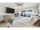 Spacious bedroom with a large bed, TV, ceiling fan, and sliding doors to a deck with beautiful water views at 667 Portside Dr, Davidson, NC 28036