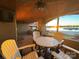 Cozy covered patio with stone floors, ceiling fans, and beautiful lake views at 667 Portside Dr, Davidson, NC 28036