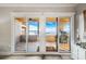 View of a large sliding glass doors opening to an outdoor patio with lake views at 667 Portside Dr, Davidson, NC 28036