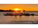 Golden sunset over the water with the community boat docks silhouetted in the sunlight at 667 Portside Dr, Davidson, NC 28036
