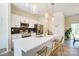 Modern kitchen features stainless steel appliances, sleek white cabinetry, and a quartz countertop island with bar seating at 709 Catawba St, Lincolnton, NC 28092