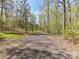 Long gravel driveway provides ample parking and enhances the property's natural setting at 7507 Reedy Creek Rd, Charlotte, NC 28215
