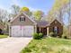 Charming home with a two-car garage, manicured lawn, and American flag displayed at 7507 Reedy Creek Rd, Charlotte, NC 28215