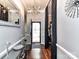 Hallway with wood floors featuring decor and a view of the front door at 7507 Reedy Creek Rd, Charlotte, NC 28215