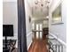 Long hallway with hardwood floors, decorated with a mirror and console table at 7507 Reedy Creek Rd, Charlotte, NC 28215