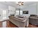 Cozy living room with fireplace, plush seating, and a ceiling fan at 7507 Reedy Creek Rd, Charlotte, NC 28215