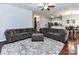 Open-concept living space with gray couches, hardwood floors, and kitchen view at 7507 Reedy Creek Rd, Charlotte, NC 28215