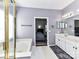 Main bathroom with double sinks, shower and tub, and ample space at 7507 Reedy Creek Rd, Charlotte, NC 28215