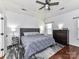 Main bedroom with hardwood floors, ceiling fan, rug, and natural light from the windows at 7507 Reedy Creek Rd, Charlotte, NC 28215