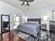 Spacious main bedroom with hardwood floors, ceiling fan, rug, and ensuite bathroom at 7507 Reedy Creek Rd, Charlotte, NC 28215
