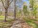 Paved walking path lined with trees offers a peaceful and scenic route through the community at 7507 Reedy Creek Rd, Charlotte, NC 28215