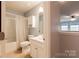 Well-lit bathroom featuring a tub-shower combo, toilet, and sink with vanity at 8828 Powder Works Dr, Huntersville, NC 28078